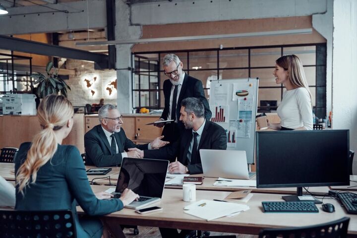 A marketing team in a meeting around a table.