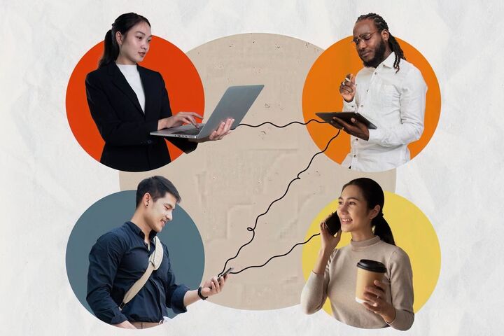 Colleagues of different ages working together at a desk.