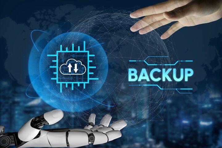 A human hand and a robot hand cup a glowing sphere labelled Backup.