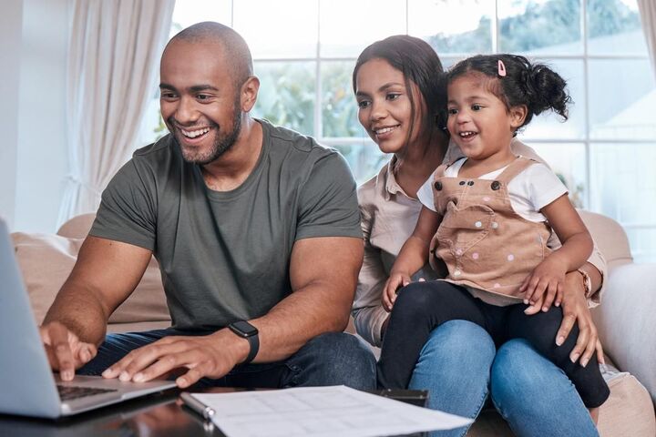 A family looking at paperwork together at a table.