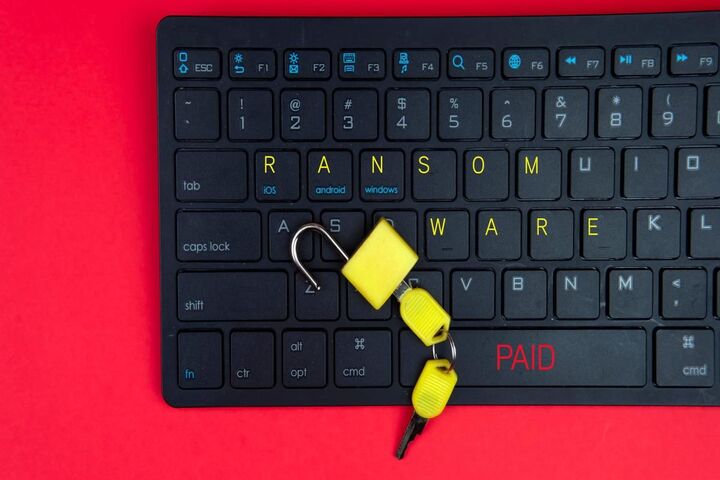 A padlock resting on a laptop keyboard.