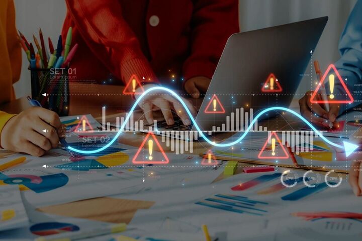 A team reviewing charts on screens in an office.