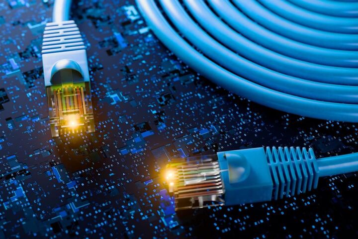 A glowing padlock above a network switch and cables.