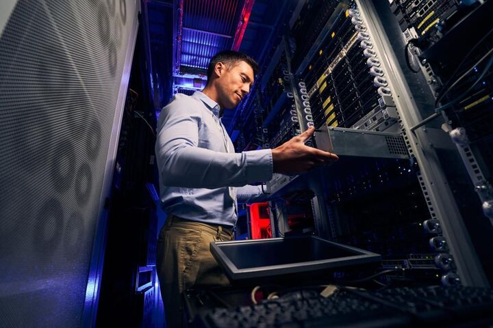 A technician working on an open desktop computer.