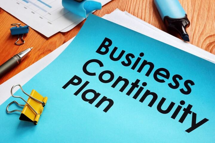 A printed business continuity plan covered in sticky notes.
