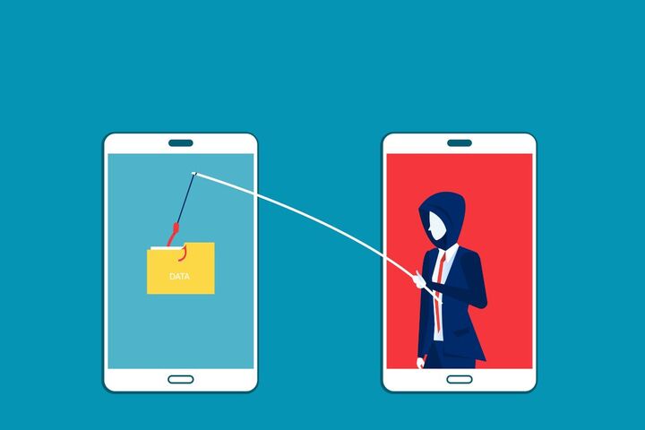 A phone and a laptop showing a data theft alert.