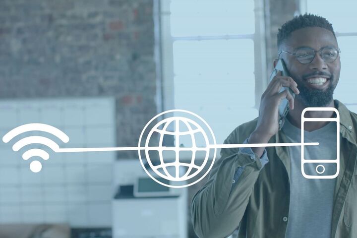 A hand holding a phone showing a wifi symbol.